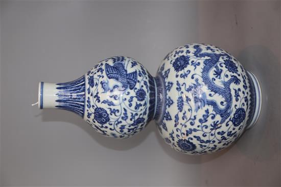 A Chinese blue and white dragon and phoenix double gourd vase , Qianlong mark but late 19th/early 20th century, H. 35.cm